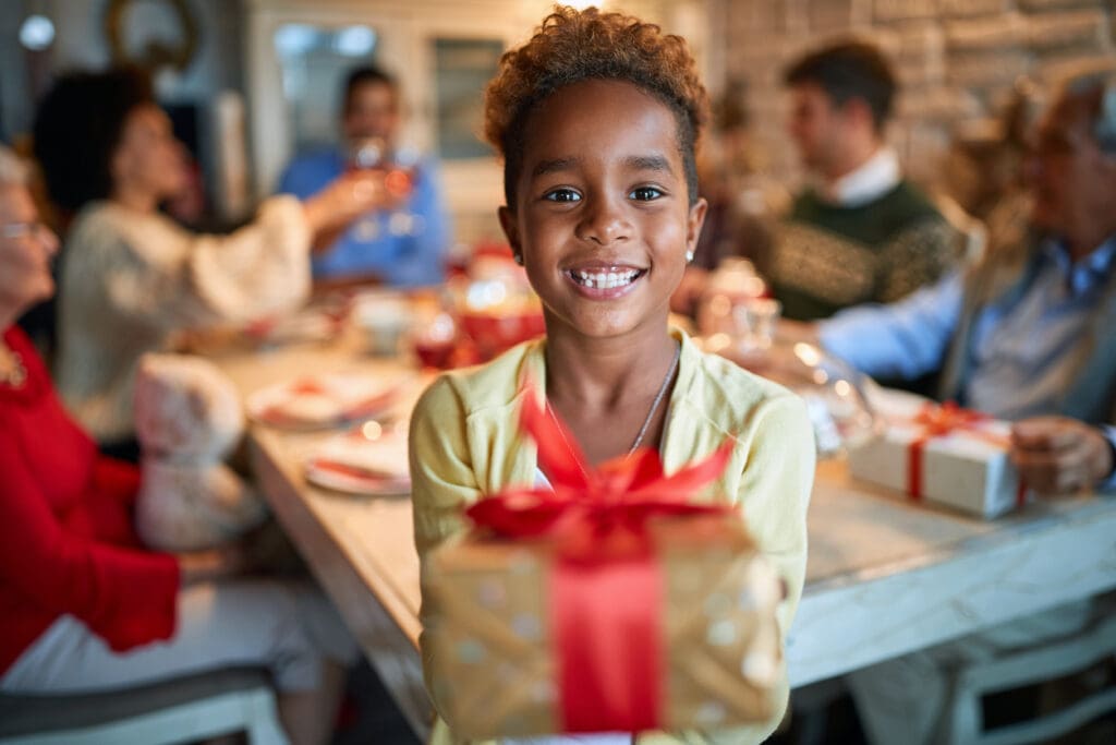 Happy girl holding Christmas present