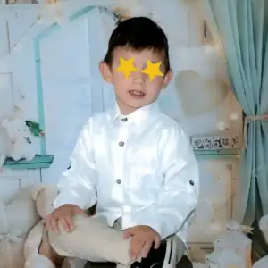 A picture of Marcus, a waiting child, with his eyes covered